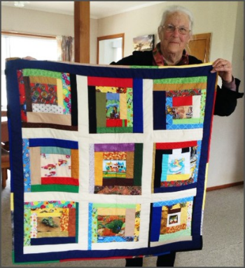 thumbnail Lyn King with one of the quilts-814